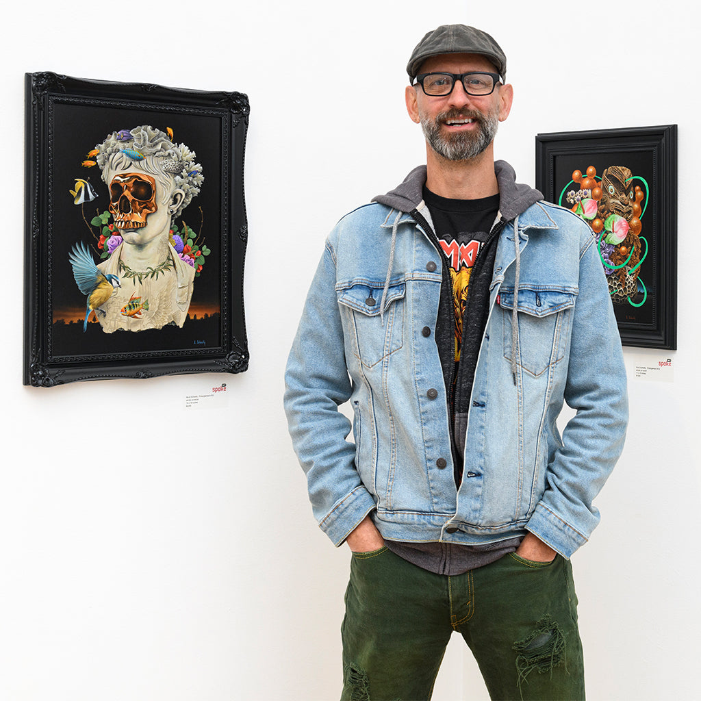 artist Scott Scheidly standing in front of two paintings from his Entanglement series