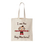 Spoke Art beige tote bag with Scott C.s illustration of a smiling cartoon child in red and black, arms wide. “I am the Hug Machine!” text above and below. Great gift for Hug Machine fans.