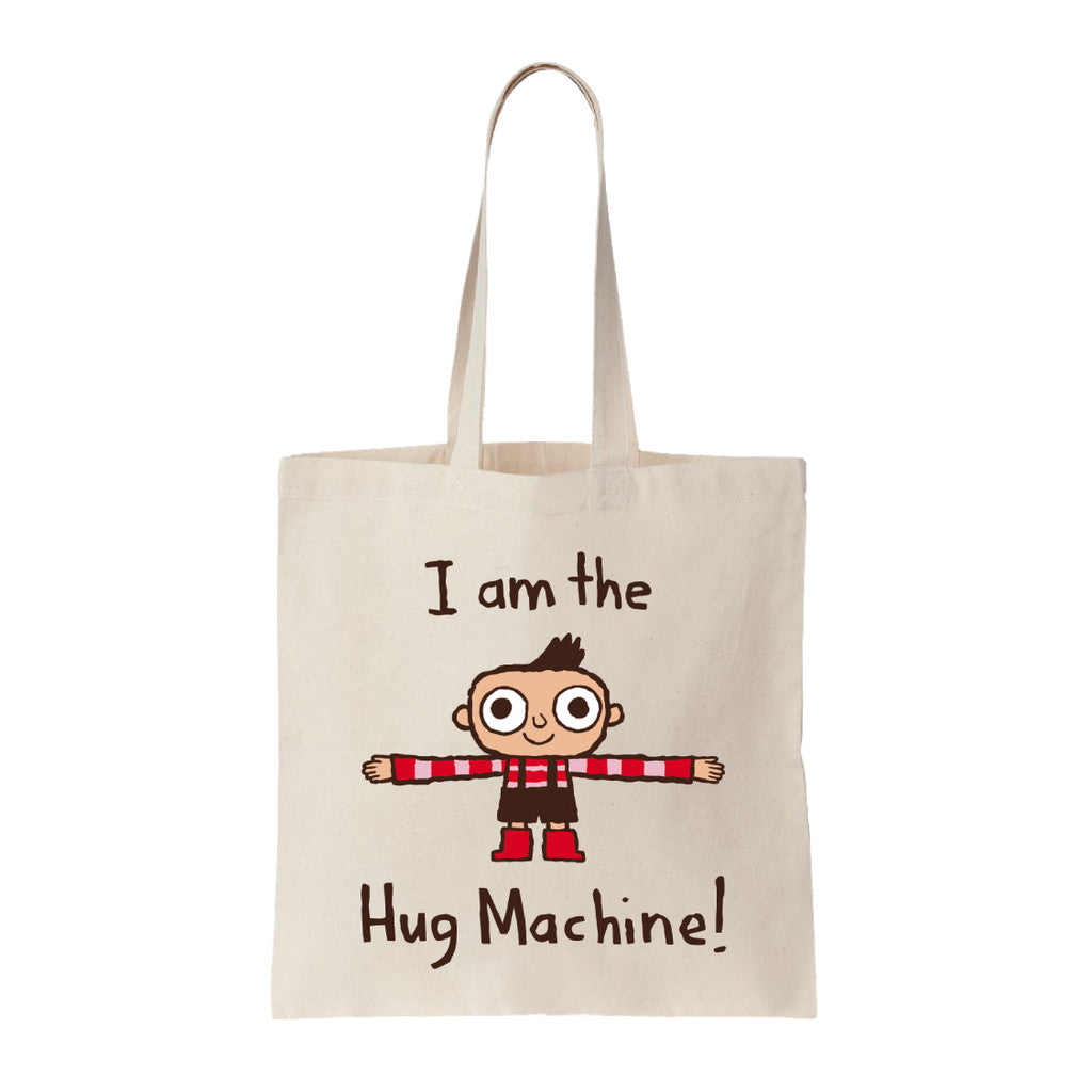 Spoke Art beige tote bag with Scott C.s illustration of a smiling cartoon child in red and black, arms wide. “I am the Hug Machine!” text above and below. Great gift for Hug Machine fans.