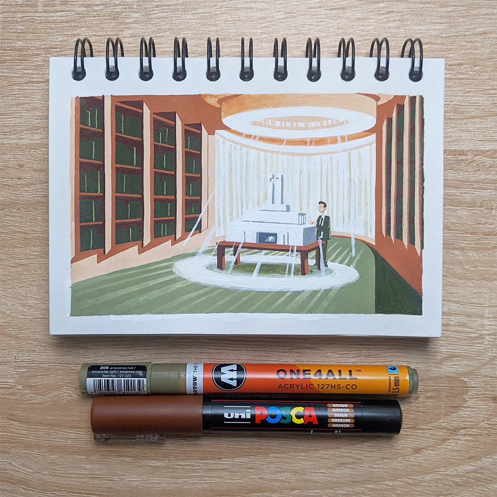 A James Chapman spiral-bound sketchbook showcases a library scene with bookshelves and windows, reminiscent of the artists style. On the wooden surface are an orange and a brown marker, potential tools from Spoke-Art.com.