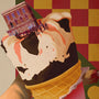 OTTO presents a surreal image of a giant ice cream cone with a building on top, surrounded by tiny people, set against a red and yellow checkered backdrop. This limited edition fine art print blends fantasy and reality for an extraordinary visual experience.