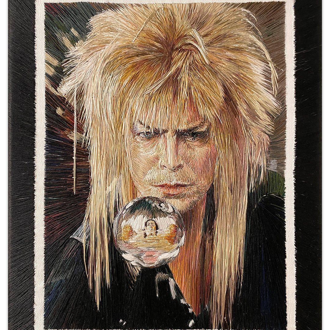 A Rose Couch painting features a person with voluminous, light blond hair like The Goblin King, gazing at a glass orb reflecting their image. A dark background with vertical color streaks enhances the mystical aura reminiscent of The Labyrinth.