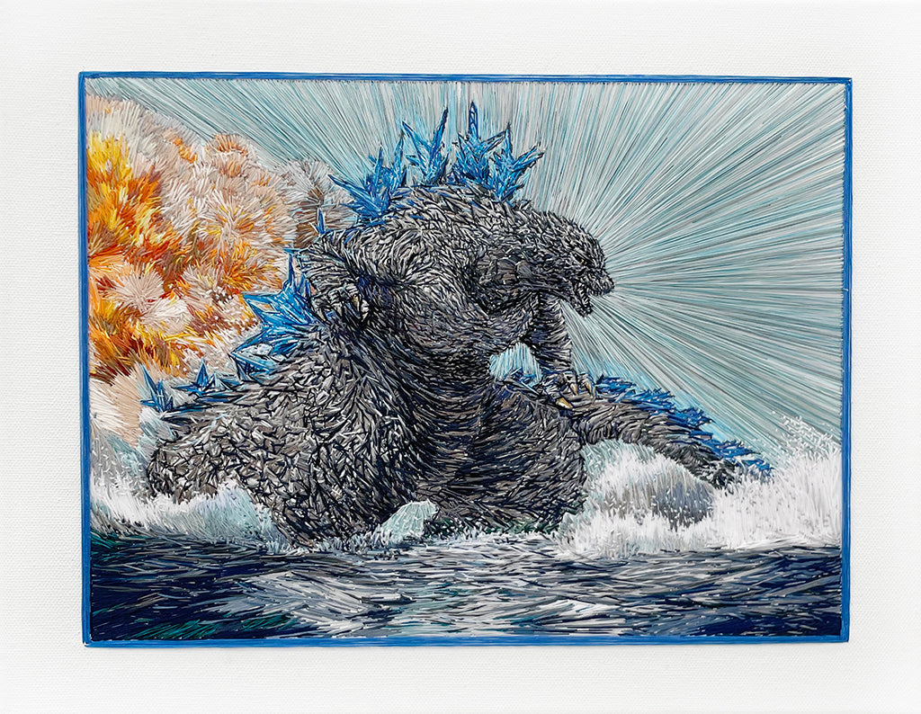 Embroidered image of Godzilla coming out of the ocean with fire in the background