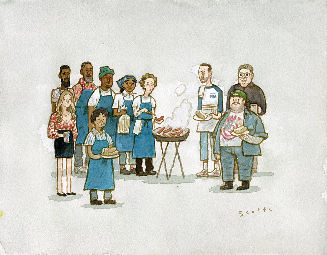 A group of people, some in blue aprons, gather around a smoking grill with hot dogs at a Scott C. barbecue. Holding plates and buns, they enjoy a relaxed outdoor event together.