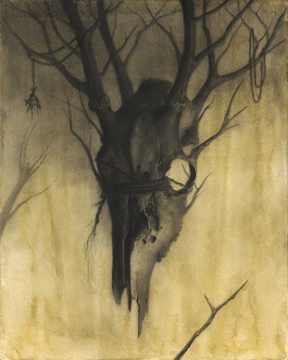 A large animal skull hangs from twisted branches against a yellow foggy backdrop, with a small charm—bringing the eerie Land of Carcosa to life for the Spoke Art 15th Anniversary Show.