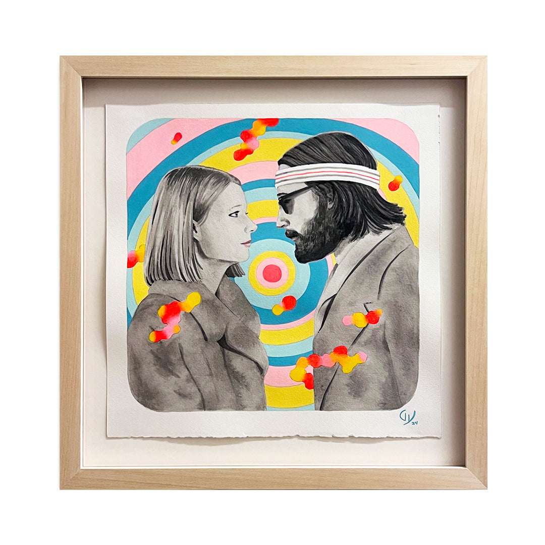 A framed artwork by Graham Yarrington features a grayscale man and woman reminiscent of Margot & Richie from The Royal Tenenbaums, facing each other against a vivid background with concentric circles and splashes of red, yellow, and orange. The man is wearing a headband.