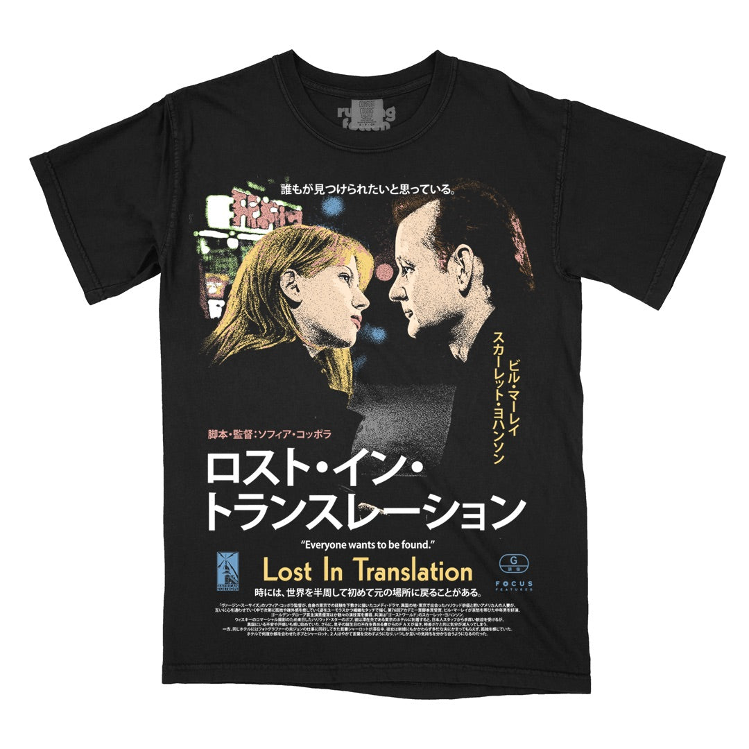 Rucking Fotten offers a 100% cotton black tee showcasing the Lost in Translation movie poster, featuring two characters facing each other with Japanese and English text, set against retro neon lights.