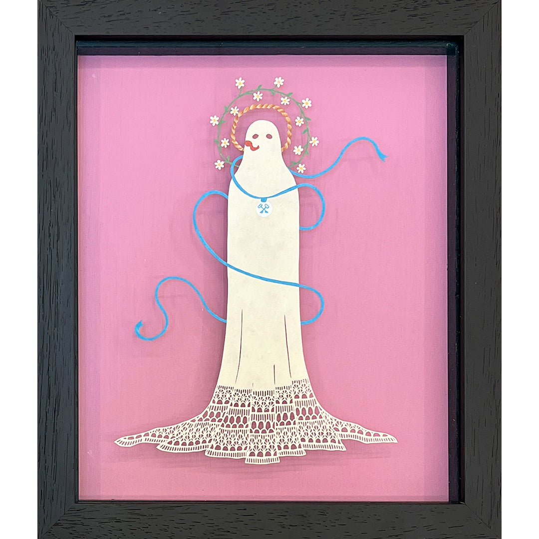 Pippa Dyrlagas framed artwork features a stylized ghost with a lace-like body on a pink background, crafted from hand-cut paper. The ghost, decorated with circular patterns and wrapped in a blue ribbon, evokes the whimsical artistry of The Grand Budapest Hotel.