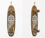 At Art Market San Francisco, a GATS skateboard with a wood finish hangs vertically like art, showcasing a black and white illustration of a snarling wolfs face. The wheels and trucks are visible, with a string attached for exhibition purposes.