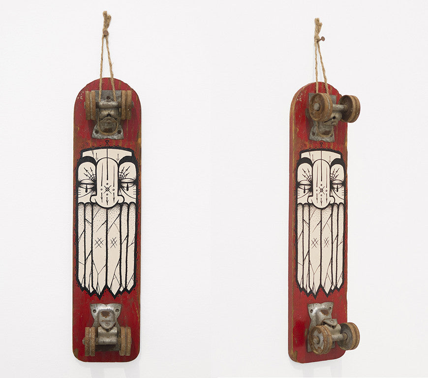 Two vertically-hung skateboard decks, painted red with a white stylized owl design, echo GATS iconic style. Visible truck and wheel assemblies are at each end, suspended by ropes. Ideal for an art market in San Francisco.