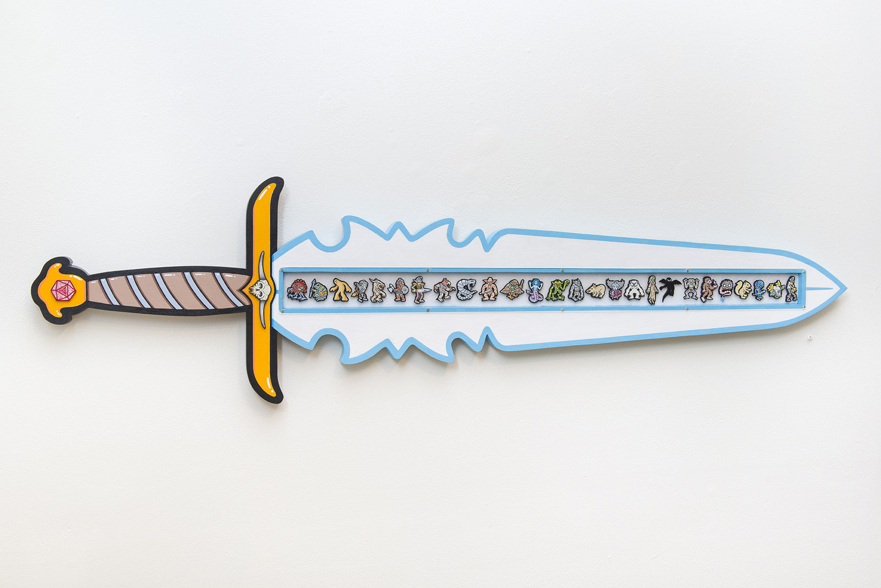 A cartoon-style sword inspired by Matt Ritchie hangs on the wall. Its wavy blue and white-edged blade features an intricate design of tiny characters, while the gold and black hilt meets a brown grip with diagonal stripes, capturing a whimsical essence similar to Feind Folio art.