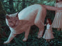 A whimsical Casey Weldon-inspired acrylic on wood painting shows a giant cat in a forest with one raised paw, next to a small girl with vibrant red hair and white dress, gently touching its leg. A partially visible second figure in white appears on the right.