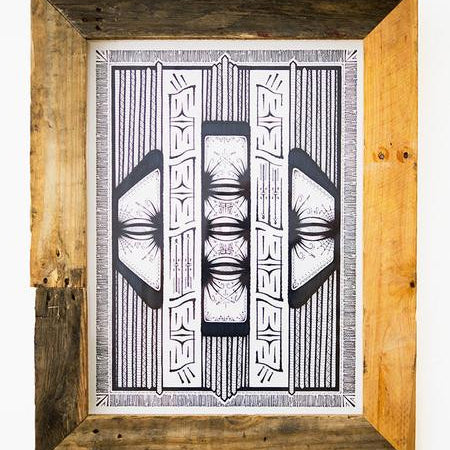 A framed monochrome abstract artwork by GATS on Bristol Board includes symmetrical geometric patterns and intricate lines. The custom rustic frame, crafted from light and dark wood planks, highlights circular, eye-like elements in the unique original illustration.
