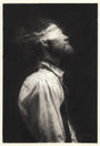 The portrait, styled in black-and-white like Karla Ortizs work, features a bearded person with a bun. Wearing a white shirt and suspenders, they gaze upward as light illuminates their face against the dark background, reminiscent of an evocative graphite on paper exhibition piece by Karla Ortiz.