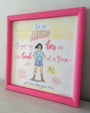 Erin Gallaghers framed mixed media artwork features a cartoon character with a pink border. It reads, Im no HERO. I put my bra on one boob at a time - just like everyone else, set against a pastel background with stylized fonts and decorative elements, ideal for an art show.