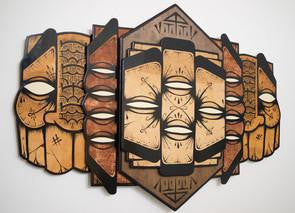 A geometric wooden wall sculpture by GATS features stylized symmetrical faces in an abstract design. Crafted with enamel on wood, it showcases intricate patterns and shapes in earthy tones of brown and beige.