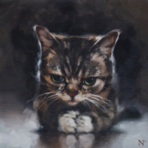 An oil on panel painting by Aaron Nagel features a grumpy-looking cat with green eyes, a striped coat, and slightly tilted back ears against a dark, blurred background. The cat lies with front paws tucked under its chest, reminiscent of works in the Lil Bub art exhibit.