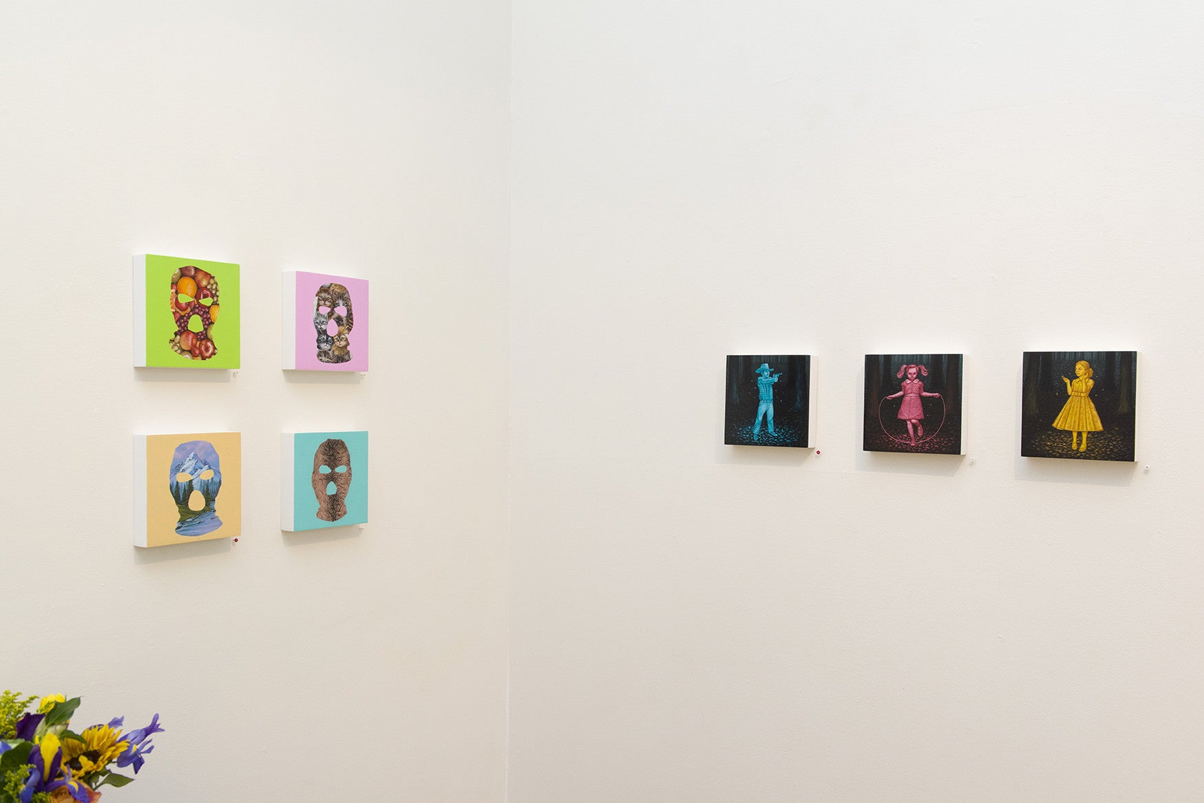 A gallery wall showcases six vibrant portraits by Casey Weldon. On the left, three smaller acrylic pieces feature stylized figures and distinct patterns, while on the right, three larger ones display figures in vivid blue, pink, and yellow shades.