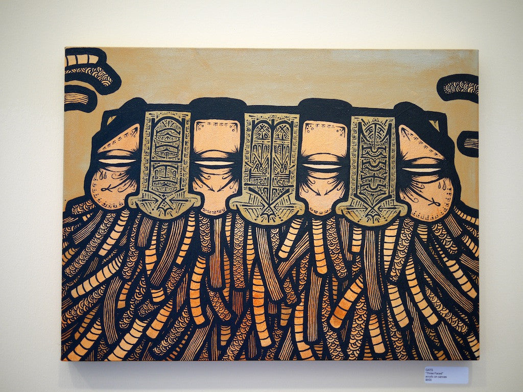 This abstract painting features five stylized faces with closed eyes and elongated features, interwoven with root-like patterns or tentacles on a beige backdrop. Its intricate detailing echoes GATS iconic Three Faced style.