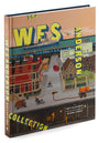 The cover of Matt Zoller Seitzs The Wes Anderson Collection showcases a stylized town scene with a train, buildings, and people. The title stands out in large, colorful lettering, providing insight into Andersons films.