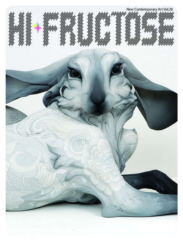 Hi-Fructose magazine, Volume 26, features a surreal sculpture of a reclining anthropomorphic rabbit adorned with intricate patterns, reminiscent of provocative paintings, set on a white background with the title at the top.
