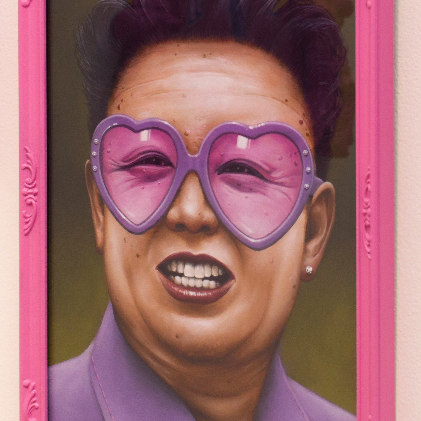 Scott Scheidlys framed painting features a man in heart-shaped pink glasses, a pink shirt, and slicked-back hair. The custom-painted pink frame highlights the vibrant colors. This fine art giclee print adds a playful touch to any room.