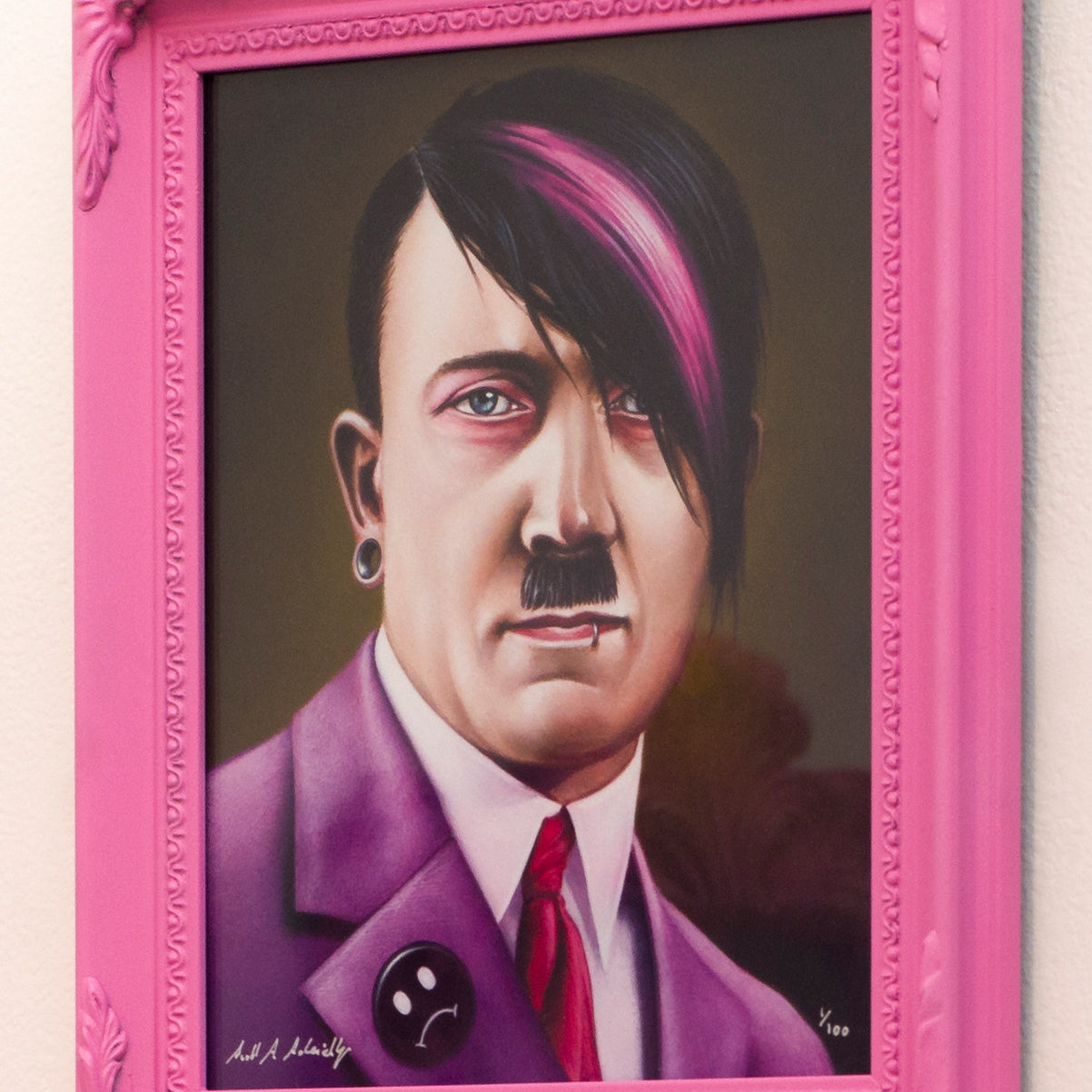 A limited edition painting by Scott Scheidly presents a historical figure with an emo twist: sporting pink and black dyed hair, a black suit with pink tie, piercings, and a sad face button. This fine art giclee print is framed in an ornate pink frame.