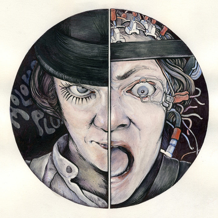 Framed artwork by Alex R. Kirzhner: On printmaking paper, a split-face image shows the left half with a mischievous expression under a black hat, and the right half with a wide-open mouth and wired eye, symbolizing transformation or duality.