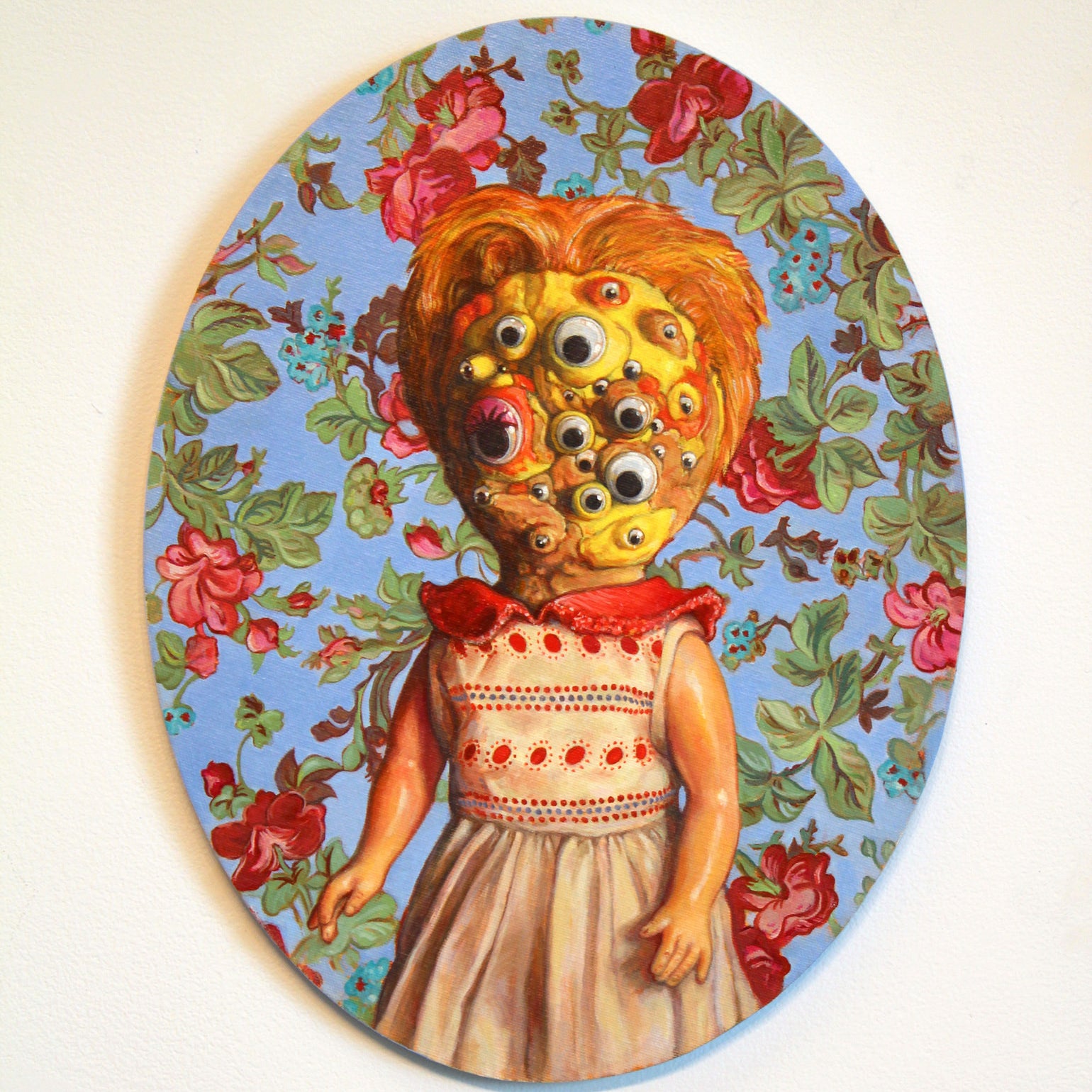 Allan Innmans oil on canvas showcases a multi-eyed doll with a red and white dress against a floral backdrop, creating an eerie, captivating effect. Now available for sale as art.