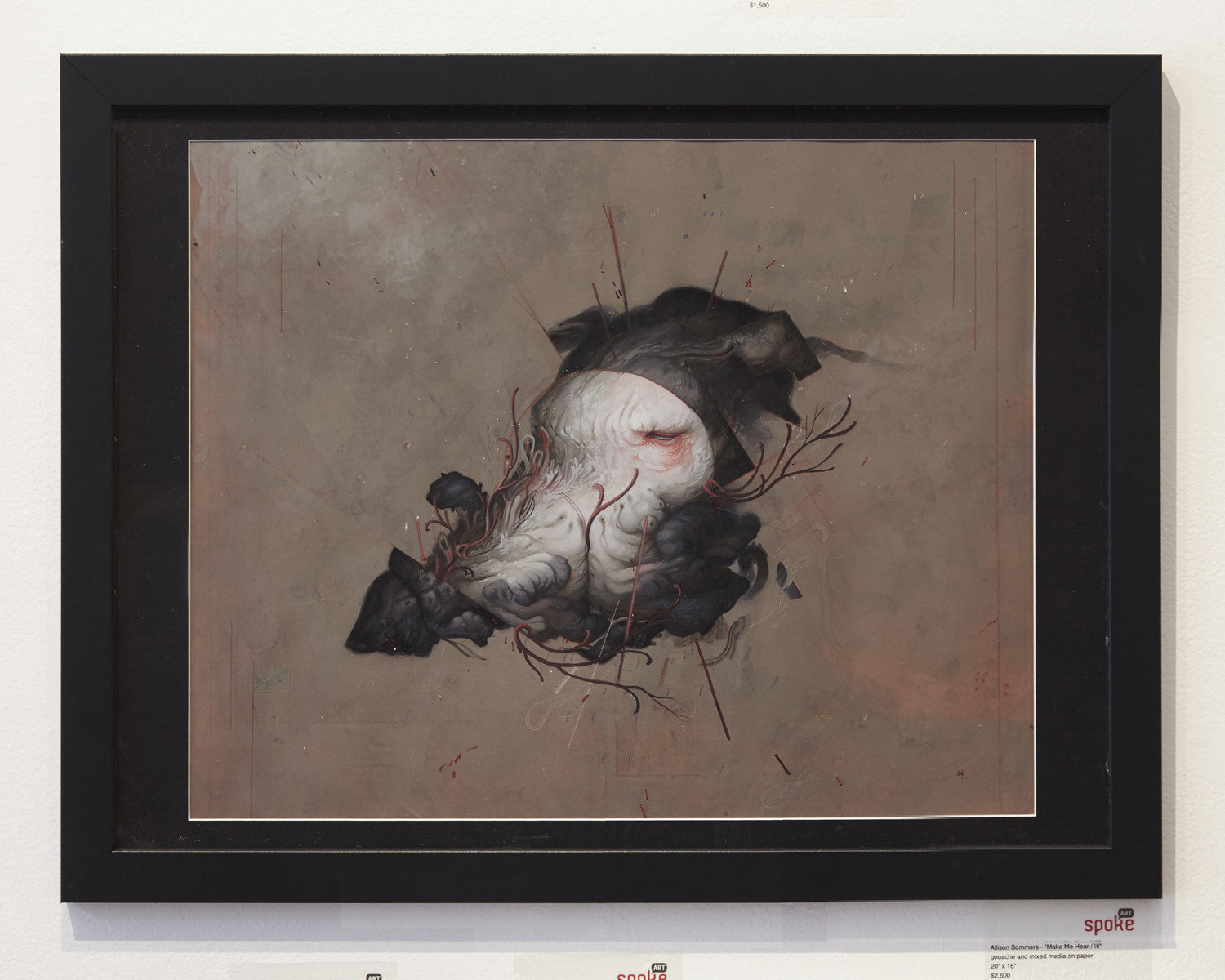Framed artwork by Allison Sommers, using gouache and mixed media, portrays an abstract dark organic skull-like form. Black swirls and red veins enliven the muted brown backdrop. Exhibited in Suggestivism: Resonance gallery with a small plaque beside it.