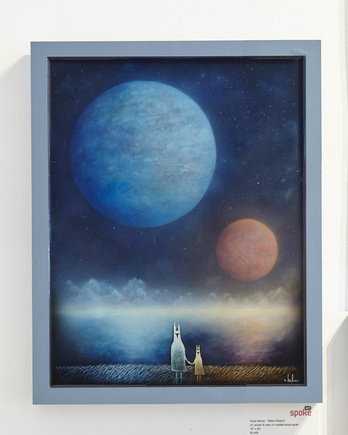This framed painting by Andy Kehoe features two white, long-eared creatures gazing at a large blue planet and a smaller orange one in the starry night sky over reflective waters, reminiscent of Silent Sisters.