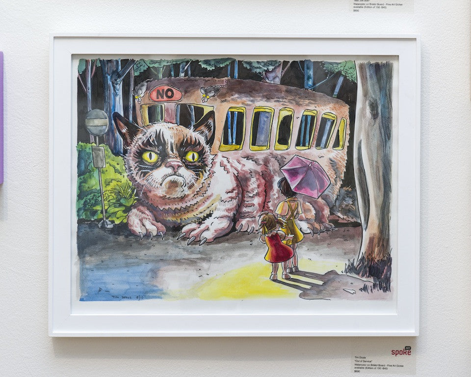 This whimsical illustration by Tim Doyle shows a large, grumpy cat bus with NO on its forehead. A person looks on with an umbrella amid trees and a road, echoing Lil Bub arts imaginative spirit.