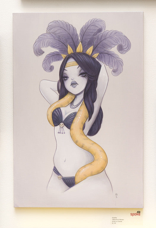 Anarkittys illustration features a woman with long dark hair, wearing a feathered headpiece and two-piece outfit. A yellow snake elegantly drapes around her neck, highlighted by the artists signature style. Set against a minimal backdrop, this captivating piece evokes the vividness of acrylic on canvas.