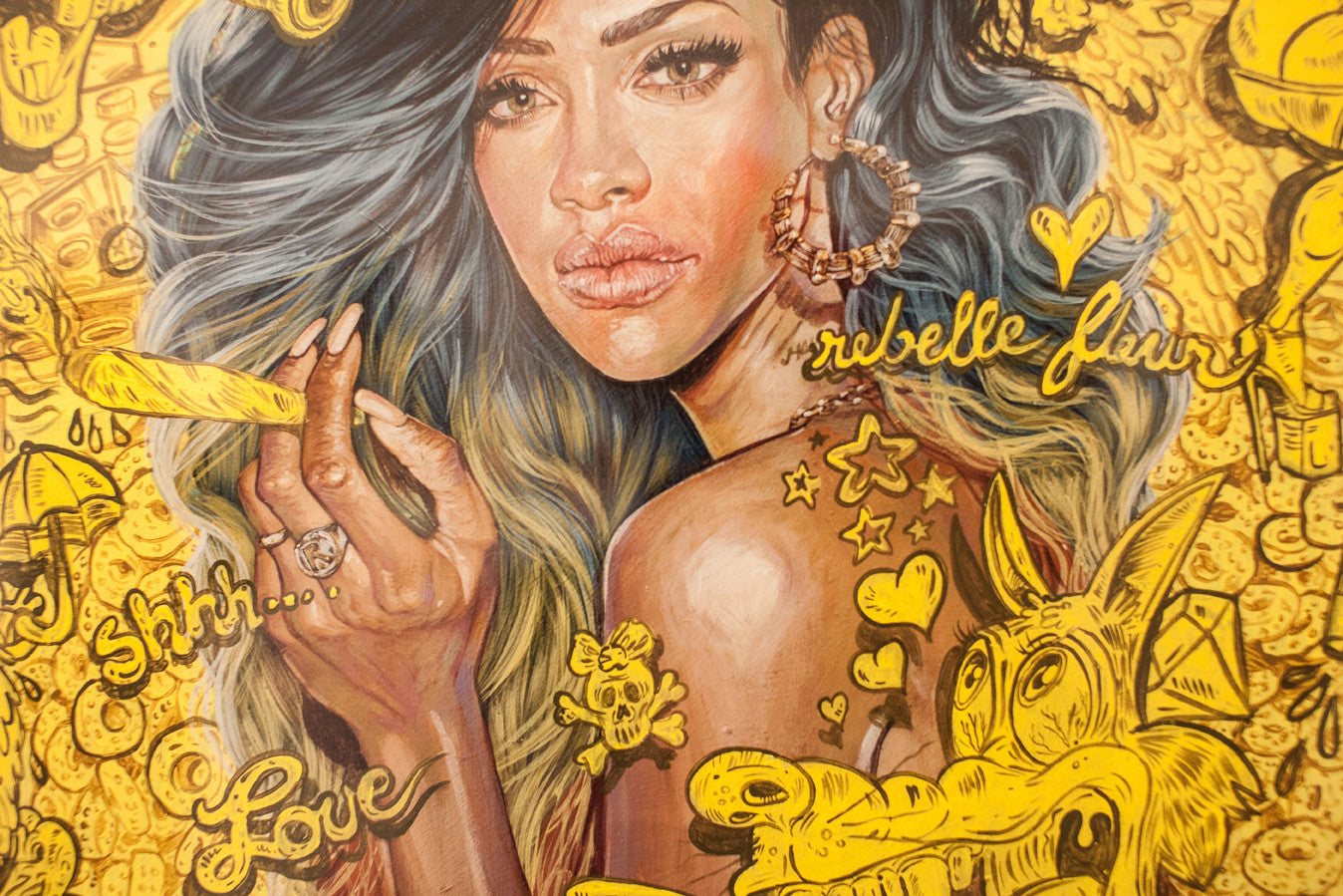 A vibrant Serge Gay Jr. artwork features a woman with long, wavy hair and large hoop earrings, surrounded by vivid yellow doodles with words like shhh... and Love, alongside stars, a skull, and a stylized dog.