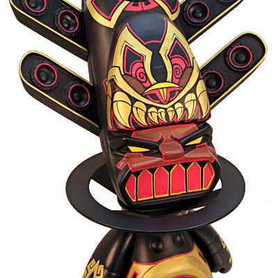 A sculpture inspired by Jesse Hernandez features a colorful, tribal totem design with intricate patterns, sharp-toothed faces, and multiple eye motifs. It blends black, red, and gold with wing-like extensions and geometric elements reflecting the Nahui Ollins cosmic essence.