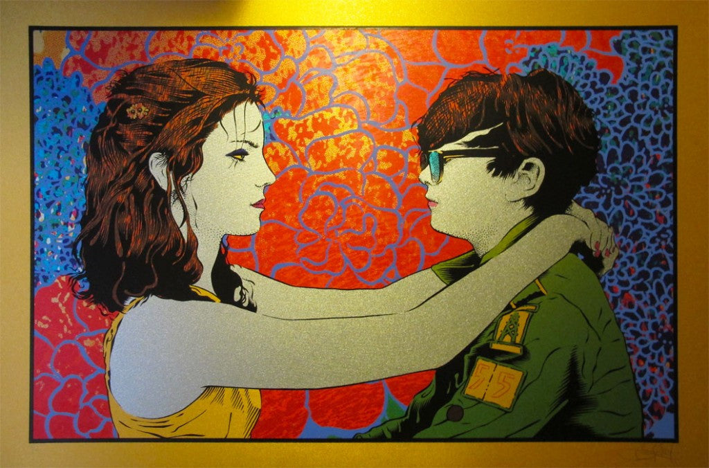 A vibrant artwork by Chuck Sperry, Kissing The Girl From Jupiter, portrays a red-haired woman in a yellow top facing someone in glasses and a green jacket, set against an abstract floral backdrop swirling with red, blue, and orange tones.