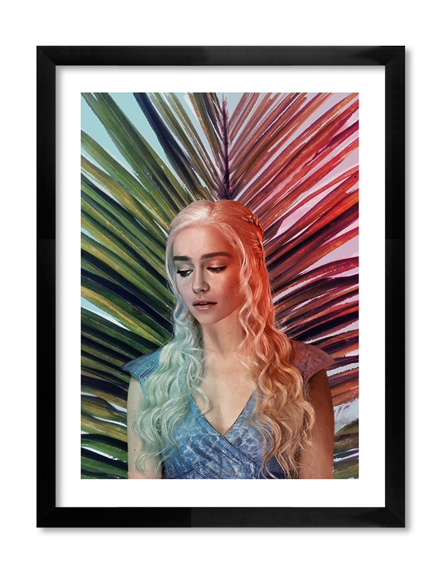 In this Stormborn collection archival pigment print by Kemi Mai, a woman with long, wavy silver hair stands before a vibrant, multicolored palm leaf backdrop. She wears a light blue dress and gazes downward serenely. The image is beautifully framed in black.