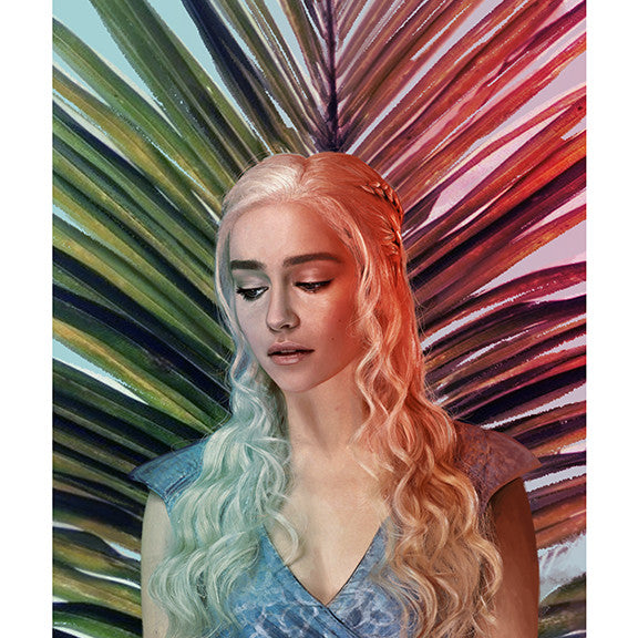In an archival pigment print by Kemi Mai, a woman with long, wavy platinum hair poses against a vibrant abstract palm leaf backdrop. Clad in a blue dress, she thoughtfully gazes downward, her soft expression evoking the grace of a Stormborn spirit within a group exhibition.
