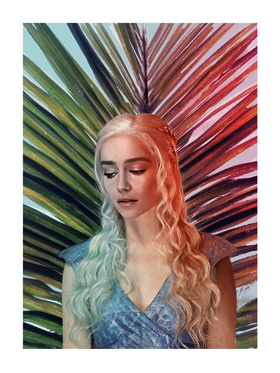 In an archival pigment print by Kemi Mai, a woman with long, wavy platinum hair poses against a vibrant abstract palm leaf backdrop. Clad in a blue dress, she thoughtfully gazes downward, her soft expression evoking the grace of a Stormborn spirit within a group exhibition.