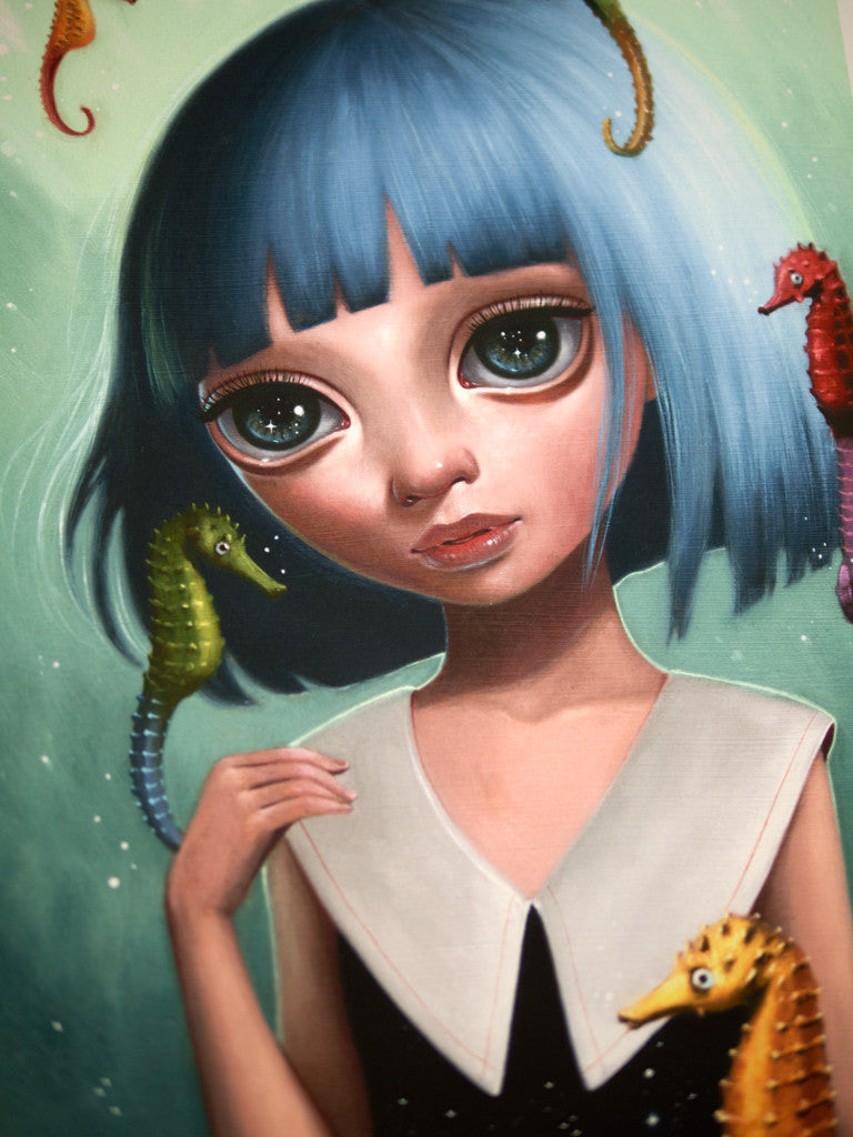 This limited edition fine art giclee print by Ana Bagayan features a girl with a blue bob haircut, large eyes, and a black dress with a white collar, surrounded by colorful seahorses on a soft green background.