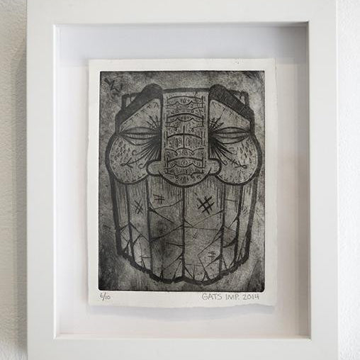 A custom-framed black and white artwork by GATS features a stylized face with intricate patterns, large eyes, and bold geometric elements. This piece embodies Bridge City flair and is signed GATS 2014 at the bottom.