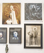 The art gallery wall features framed artworks from Michael Ramstead, showcasing enchanting fantasy portraits and monochrome sketches, including regal figures and abstract designs resembling Daenerys Targaryen. At the bottom, a small statue is artfully displayed.