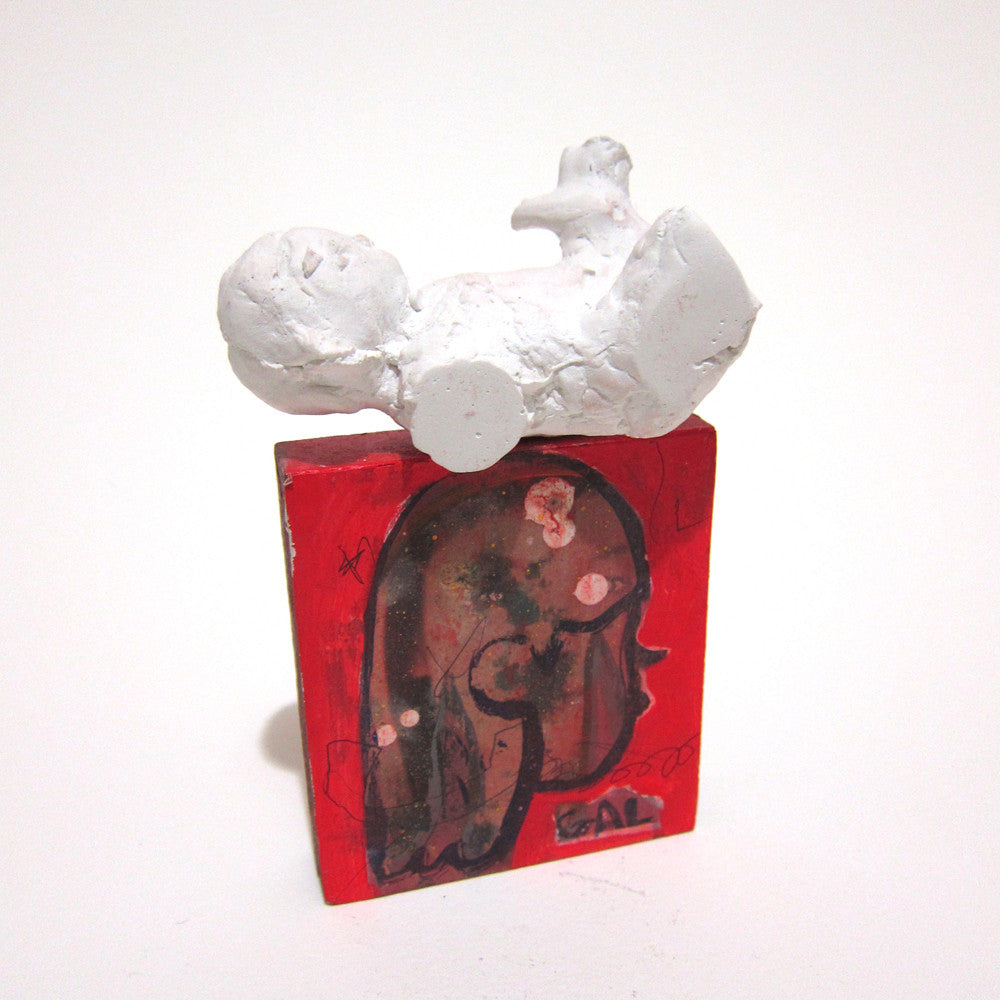 Tessar Los mixed media red sculpture features a white abstract reclining figure on its back. The rectangular base is adorned with Los dark-toned animal and human drawings, and the name DAL is elegantly inscribed at the bottom.