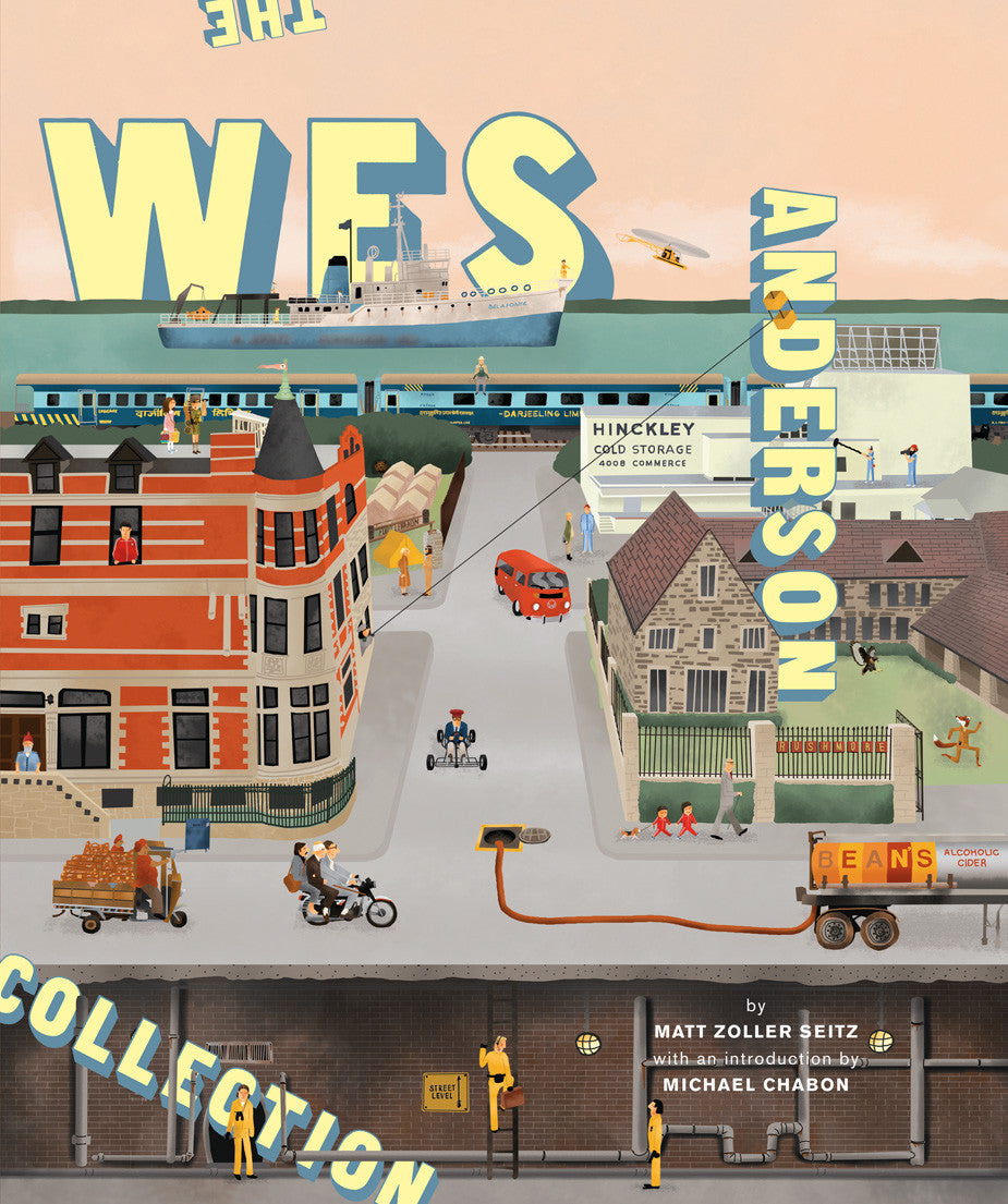 The illustrated cover of The Wes Anderson Collection by Matt Zoller Seitz features a whimsical town scene with a red brick building, a cyclist, and lively activities. The title and authors name prominently offer insight into Wes Andersons filmography and behind-the-scenes photos.