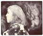 Amliv Sotomayor presents a surreal pencil drawing of a woman in profile, her long hair blending into abstract cloud-like forms. She wears a floral-patterned garment. Crafted on Moleskine paper, the monochrome art boasts fine shading and is ideal for custom framing for an elegant display.