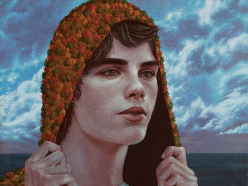A person with a contemplative expression pulls the hood of a textured, colorful garment over their head, set against a dynamic, cloudy sky above a calm sea—a scene reminiscent of Casey Weldons vivid style.