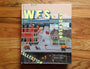 Matt Zoller Seitzs The Wes Anderson Collection features a whimsical cityscape cover with buildings, vehicles, and characters that encapsulate Andersons unique style and explore his films with behind-the-scenes photos.