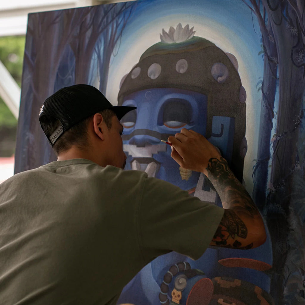 Photo of artist Pemex painting in his studio.