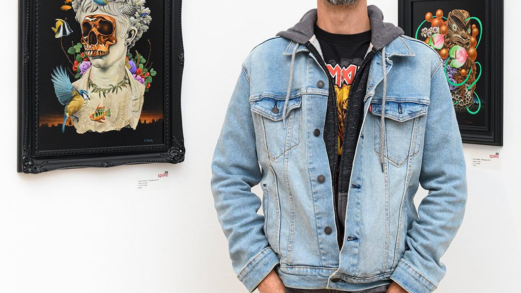 artist Scott Scheidly standing in front of several of his paintings from Entanglement on view at Spoke Art in San Francisco