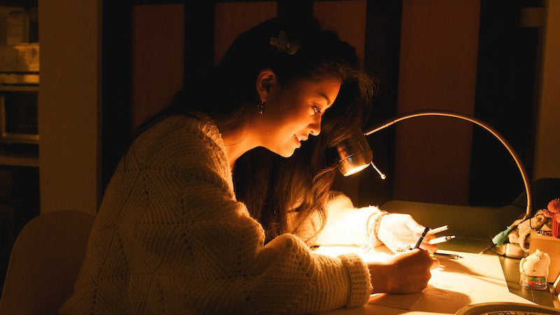 photo of JP Neang working on a drawing in her studio